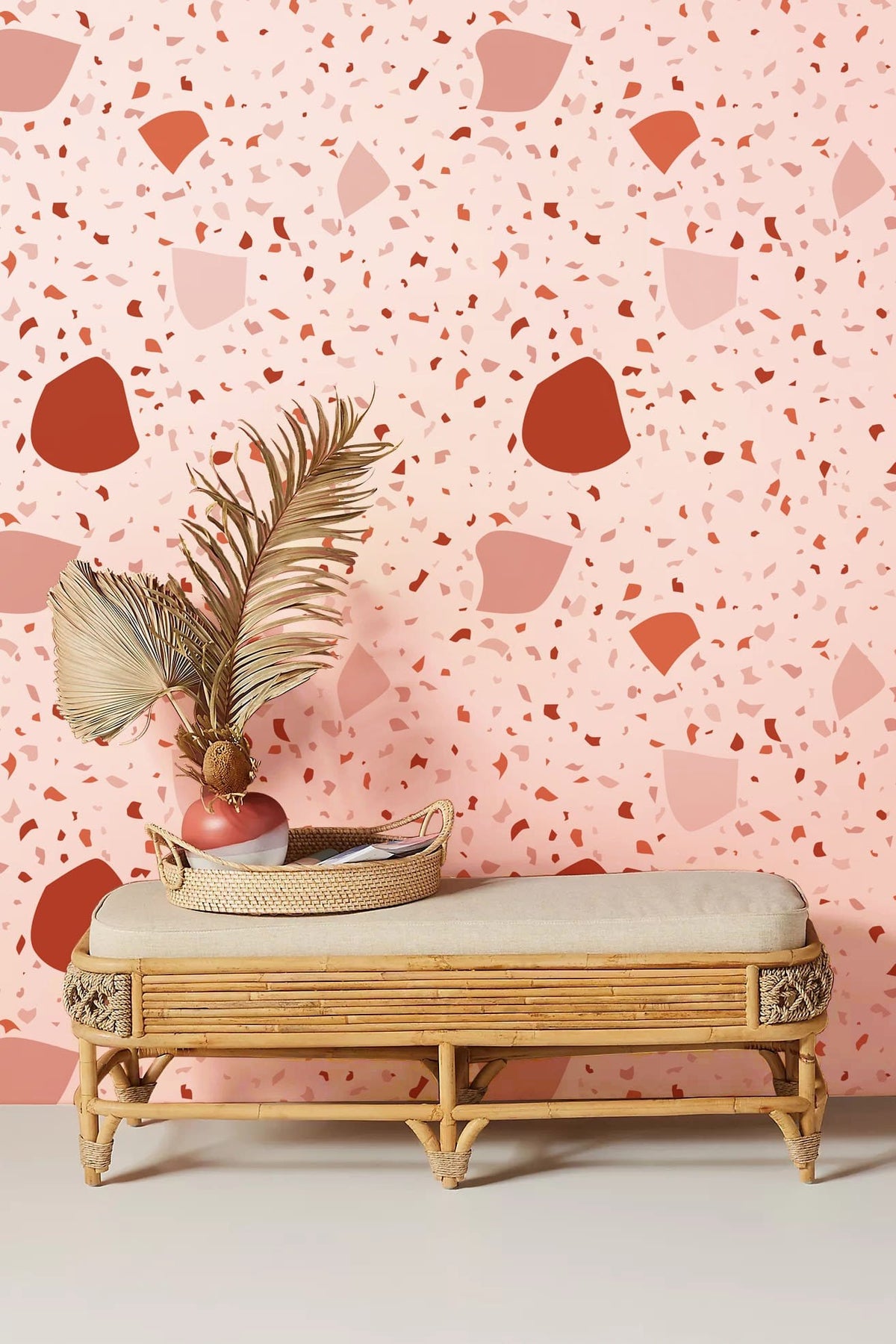 Modern Terra Cotta and Cream Terrazzo Wallpaper, chic interiors, wicker bench, neutral flooring.