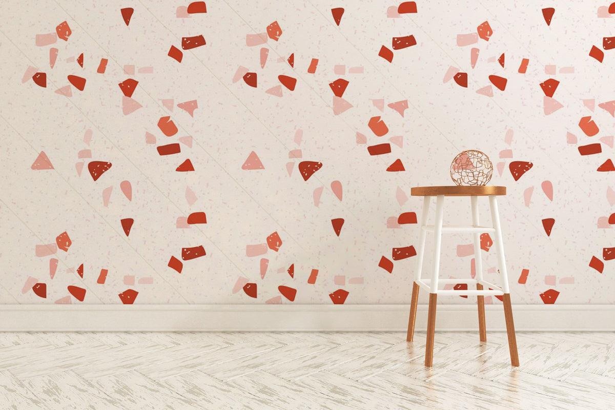 Modern red and pink geometric pattern wallpaper with wooden stool, white chevron flooring in bright room.