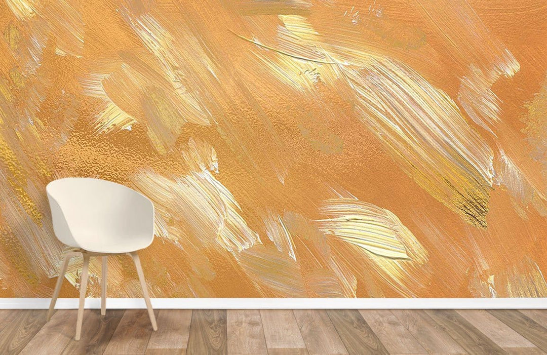 Golden Brushstroke Mural Wallpaper in earthy tones, featuring wooden flooring and a white chair.