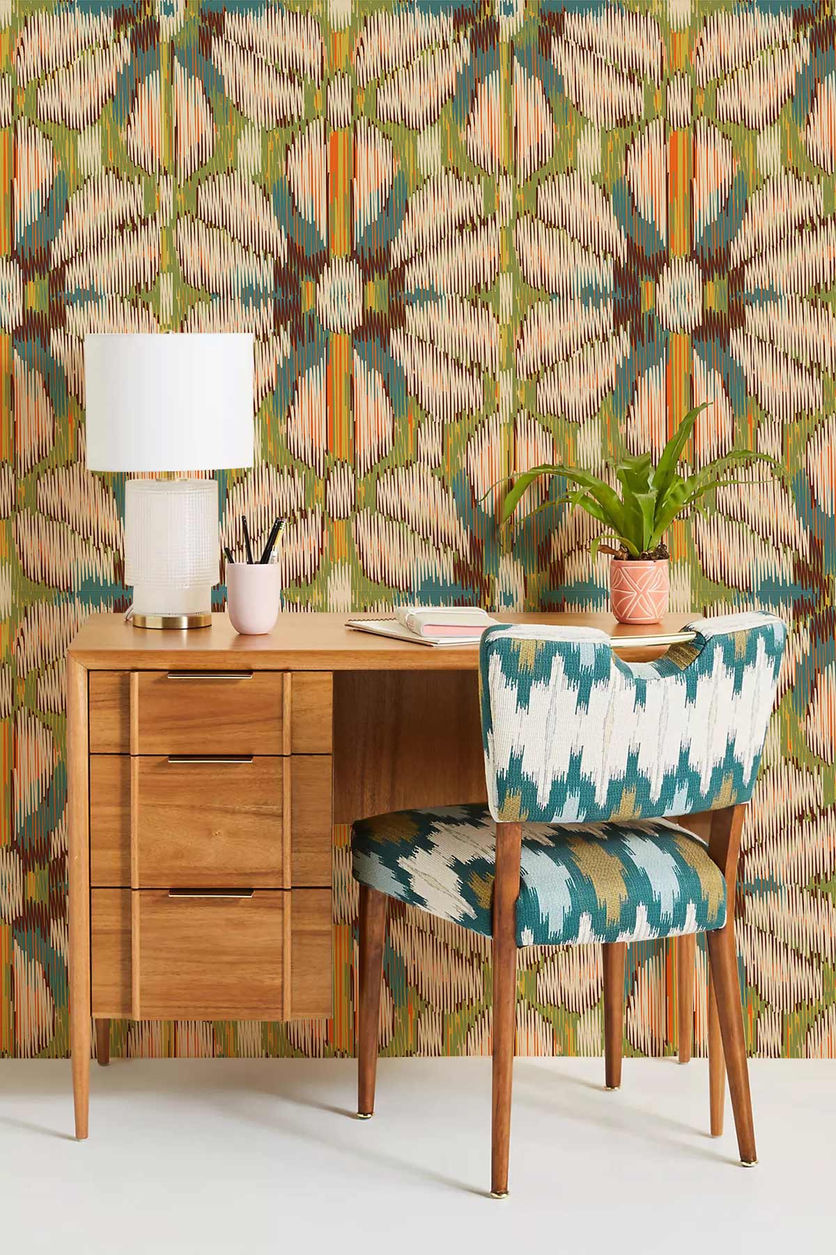 Vibrant geometric wallpaper in earthy tones, wooden desk, patterned chair, stylish home office decor.