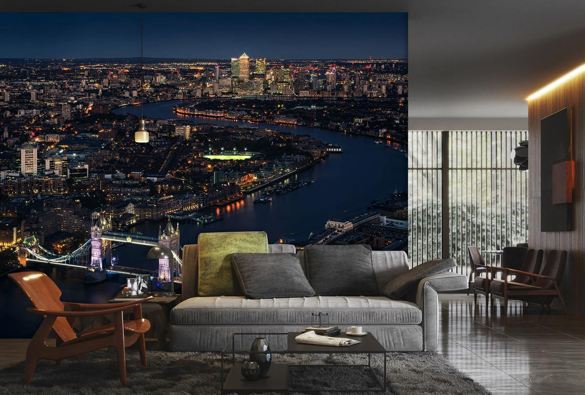 London Night Skyline Mural Wallpaper in modern living room with grey sofa, wooden chairs, glass flooring.