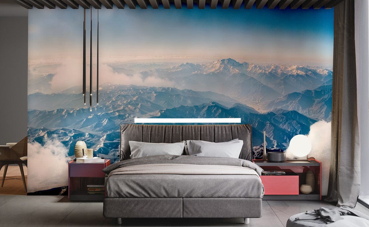 Panoramic Mountain Vista mural, grey bed, modern bedroom, stylish pendant lights, sleek flooring, red side tables.