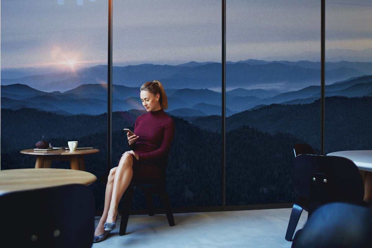 Blue Mountain Sunrise scenic mural wallpaper in tranquil room with contemporary furniture and neutral flooring.