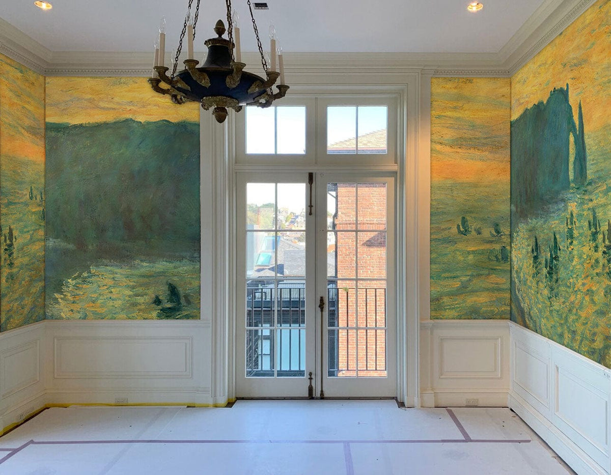 Impressionist Coastal Sunset mural in room, chandelier, white panelling, large windows, hardwood flooring.