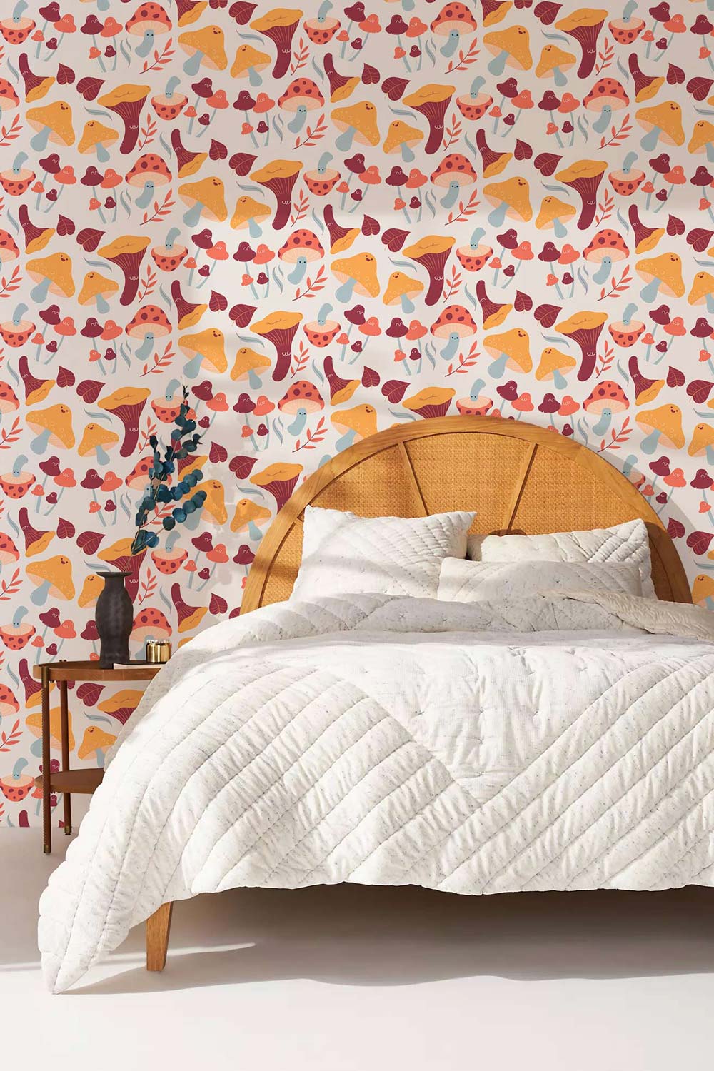 Autumn Forest Foxes wallpaper with rattan bed, white quilted duvet, in a cosy bedroom setting.