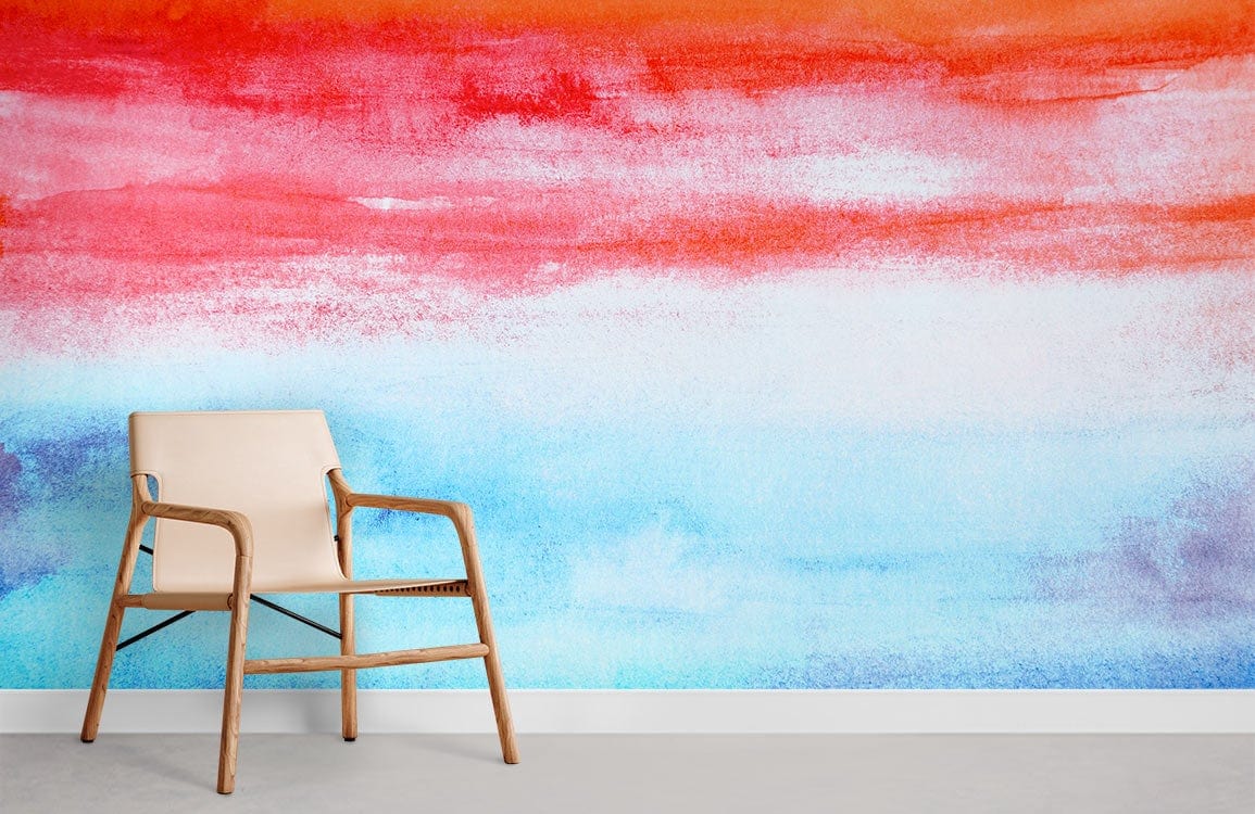 Vibrant sunset watercolour mural wallpaper with red, orange, blue gradient; beige chair, grey flooring.