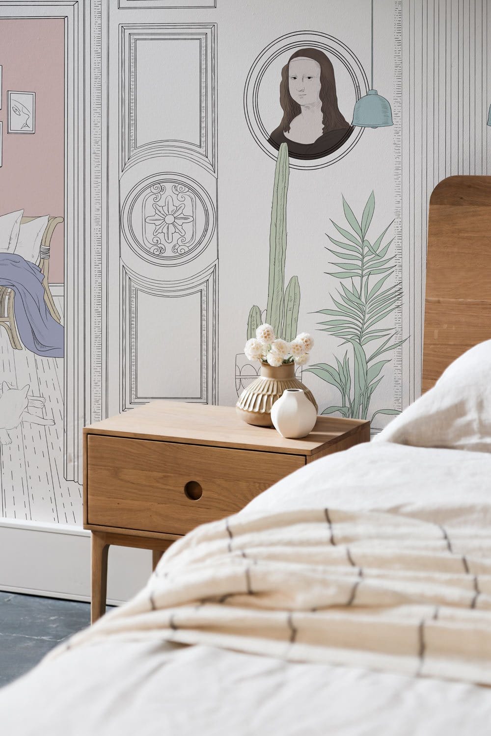 Vintage Chic architectural mural wallpaper with pastel accents, wooden bedside table, beige bedding, cosy bedroom.