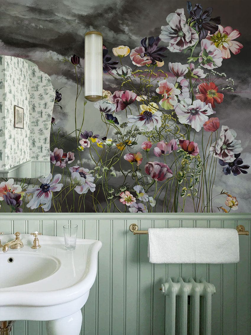 Floral mural wallpaper in bathroom with vintage sink, pastel panelled walls, and antique radiator.