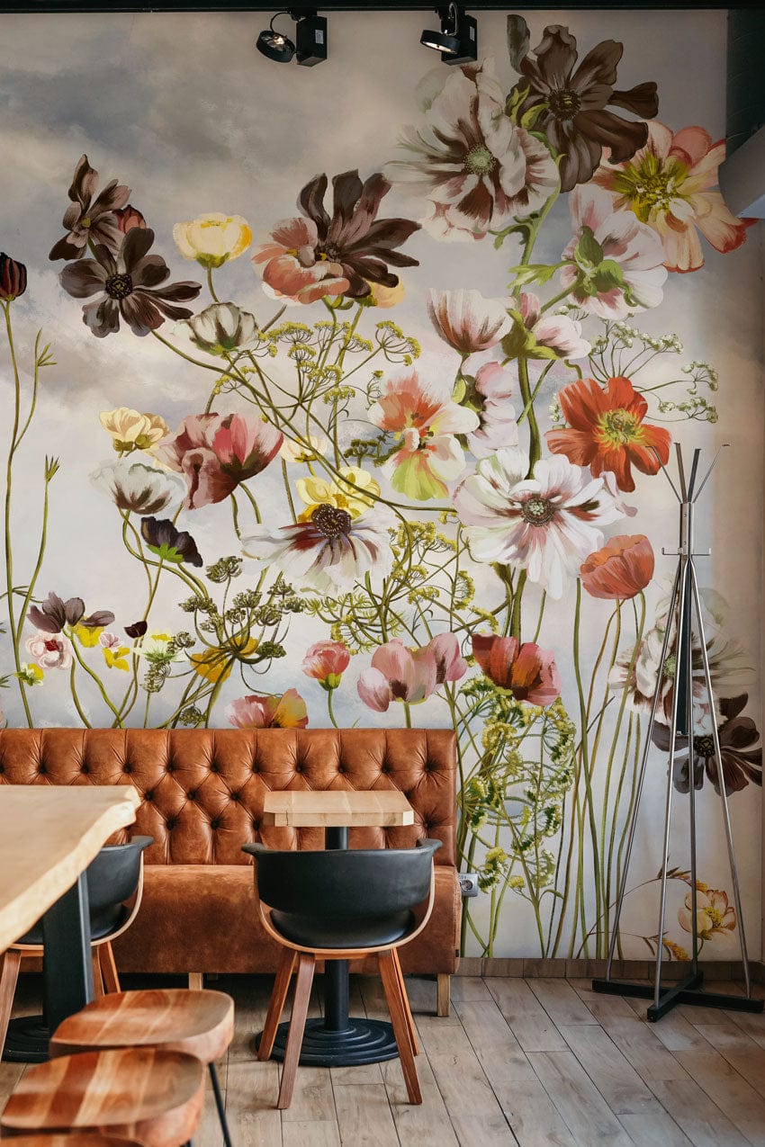 Vintage floral watercolour mural wallpaper, leather sofa, wooden flooring, contemporary café setting, soft pastels.