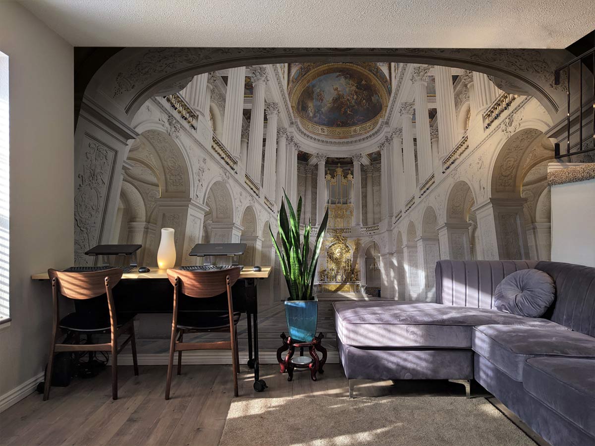 Elegant Classical Architecture mural wallpaper complements grey sectional sofa, light wooden flooring, home office decor.