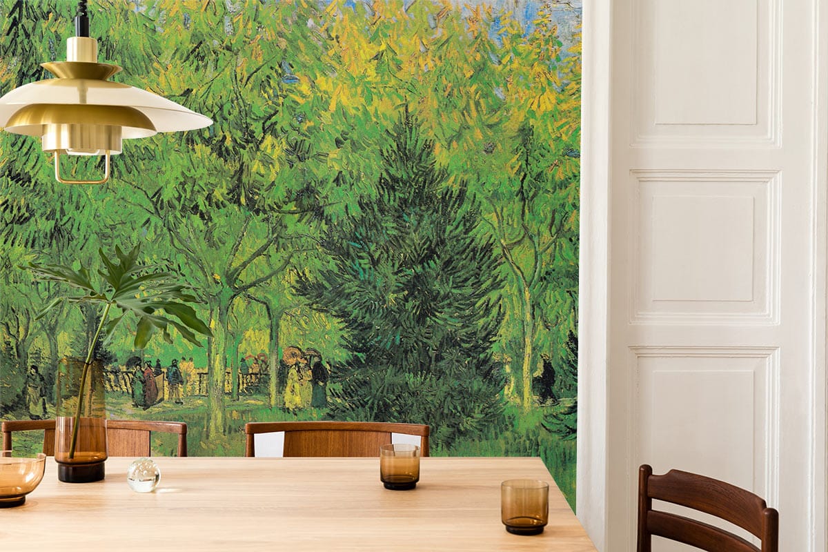 Vincent Van Gogh mural wallpaper in dining room, wooden table, chairs, pendant light, green park landscape.