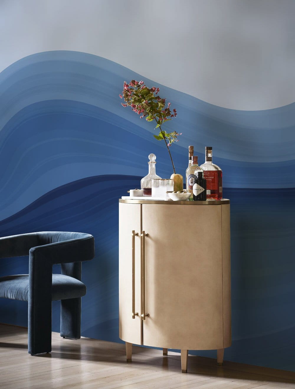 Elegant blue wave gradient mural wallpaper with modern chair, light wood flooring, and beige cabinet.