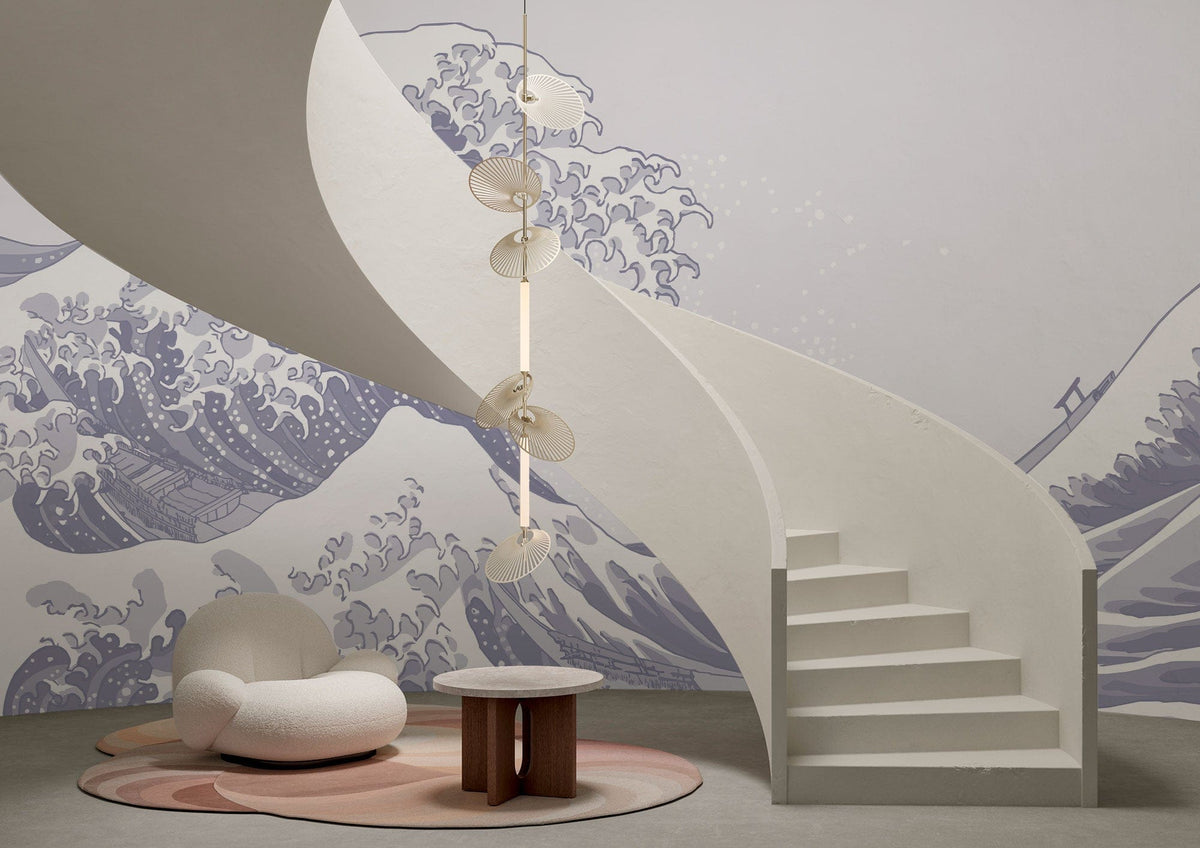 Elegant Indigo Great Wave Mural Wallpaper, spiral staircase, modern cream chair, grey flooring, pendant light.