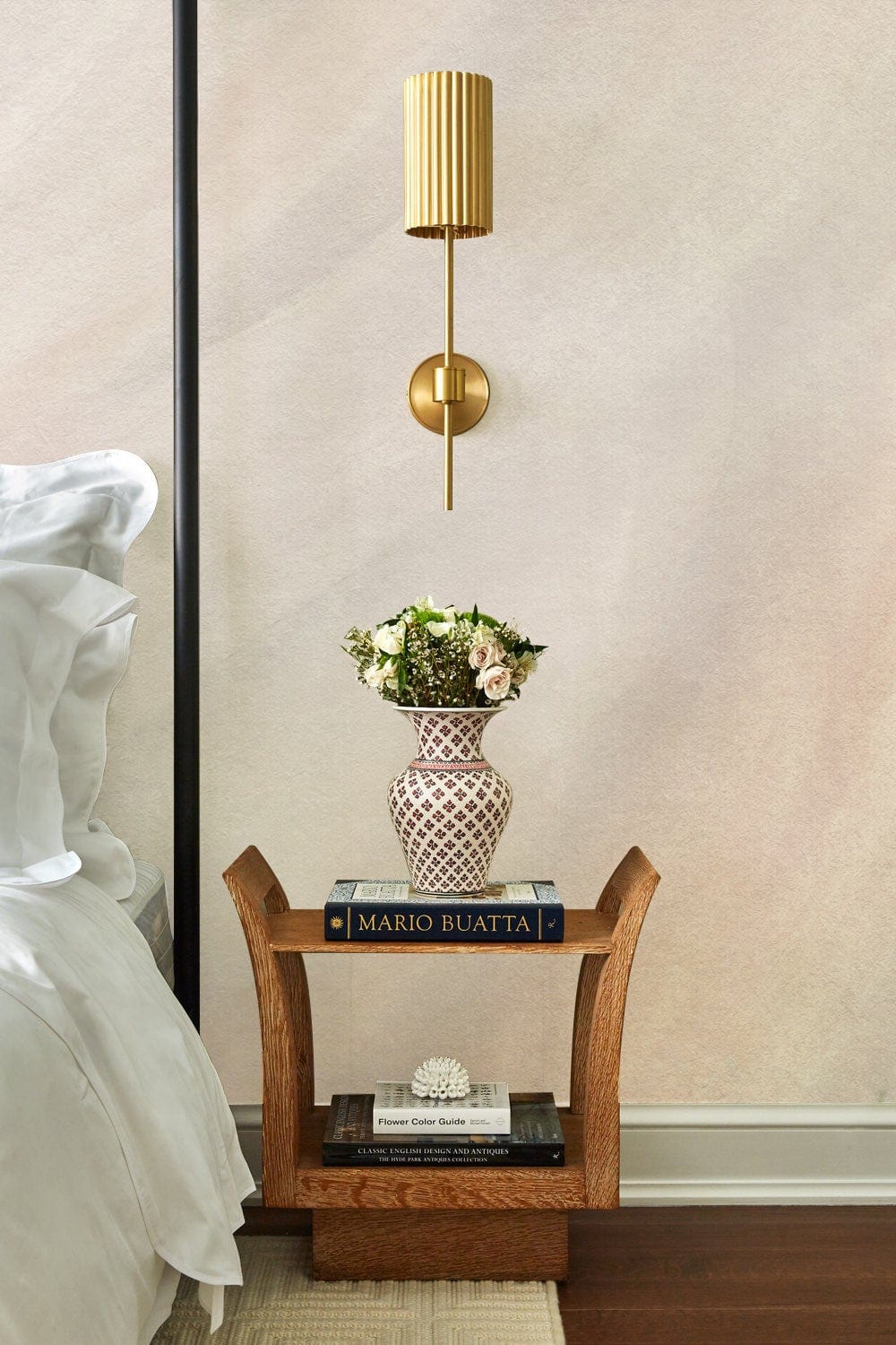 Modern Beige Minimalist Texture Wallpaper in elegant bedroom with wooden side table and wall sconce.