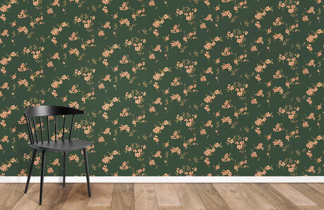 Vintage Floral Elegance wallpaper with green and peach botanical pattern, wood flooring, black chair.
