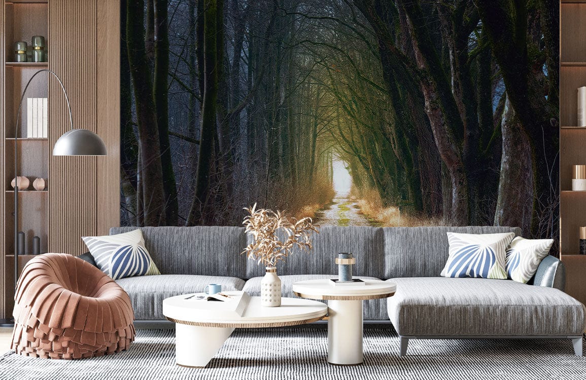 Enchanted Forest Pathway Mural Wallpaper with grey sofa, round tables, striped rug in living room.