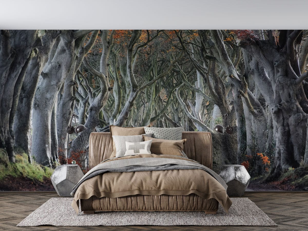 Autumn forest mural wallpaper in rustic bedroom with brown bedding, grey carpet, and geometric side tables.