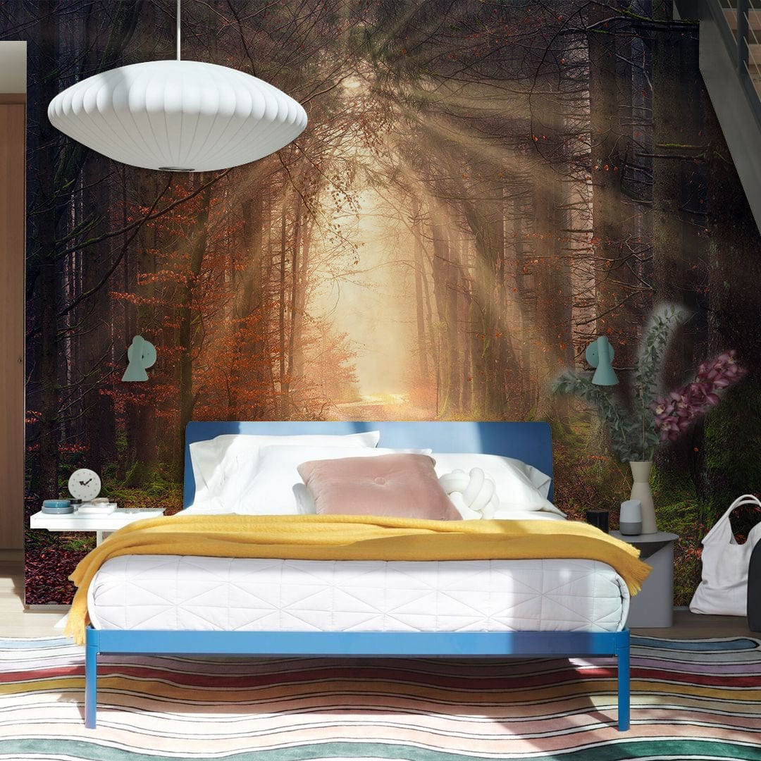 Enchanted Forest mural wallpaper in bedroom with blue bed, wooden flooring, and modern pendant light.