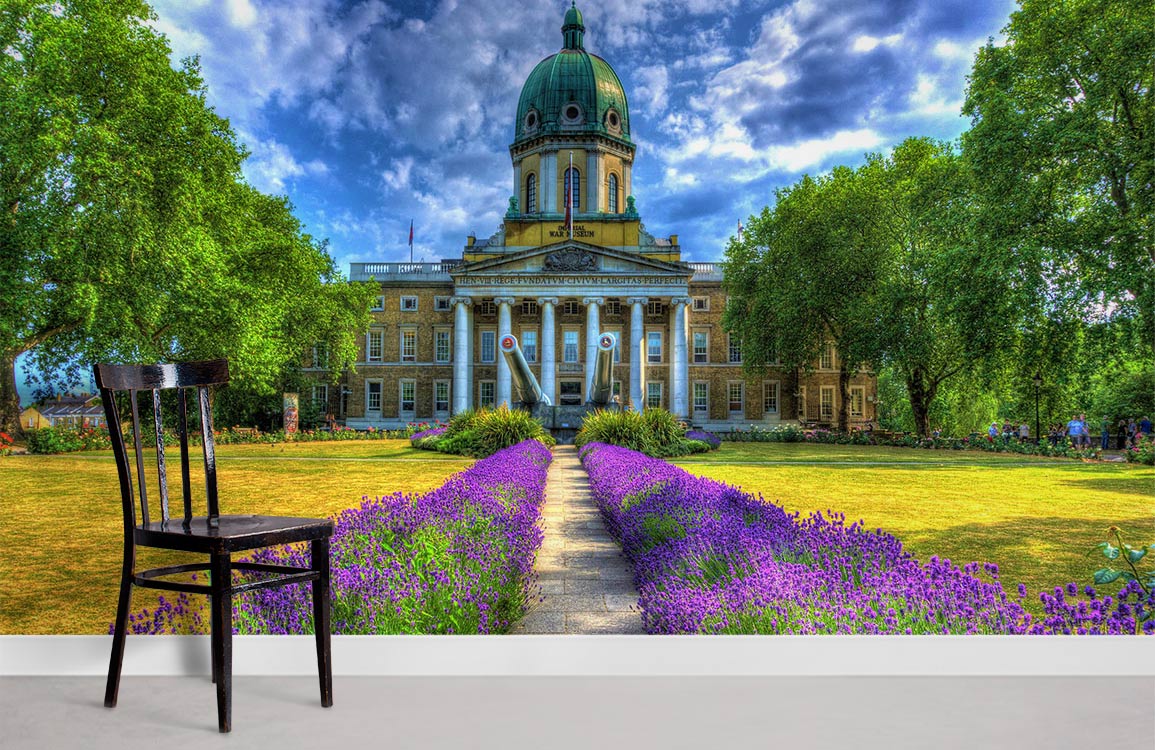 Historic Garden Pathway Mural Wallpaper features lavender and grand architecture beside simple chair, light flooring.
