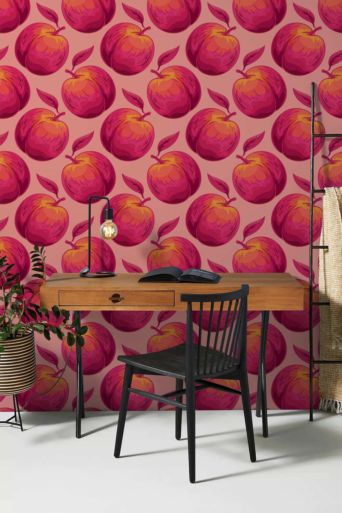 Vibrant peach patterned wallpaper in home office with wooden desk and black chair.