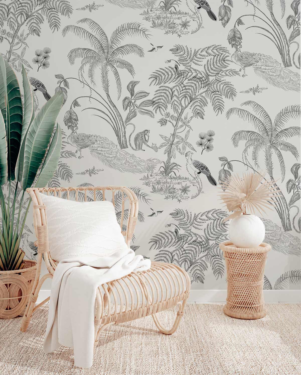Tropical Vintage Jungle Grey Botanical Wallpaper in room with rattan chair, rug, and green decor.