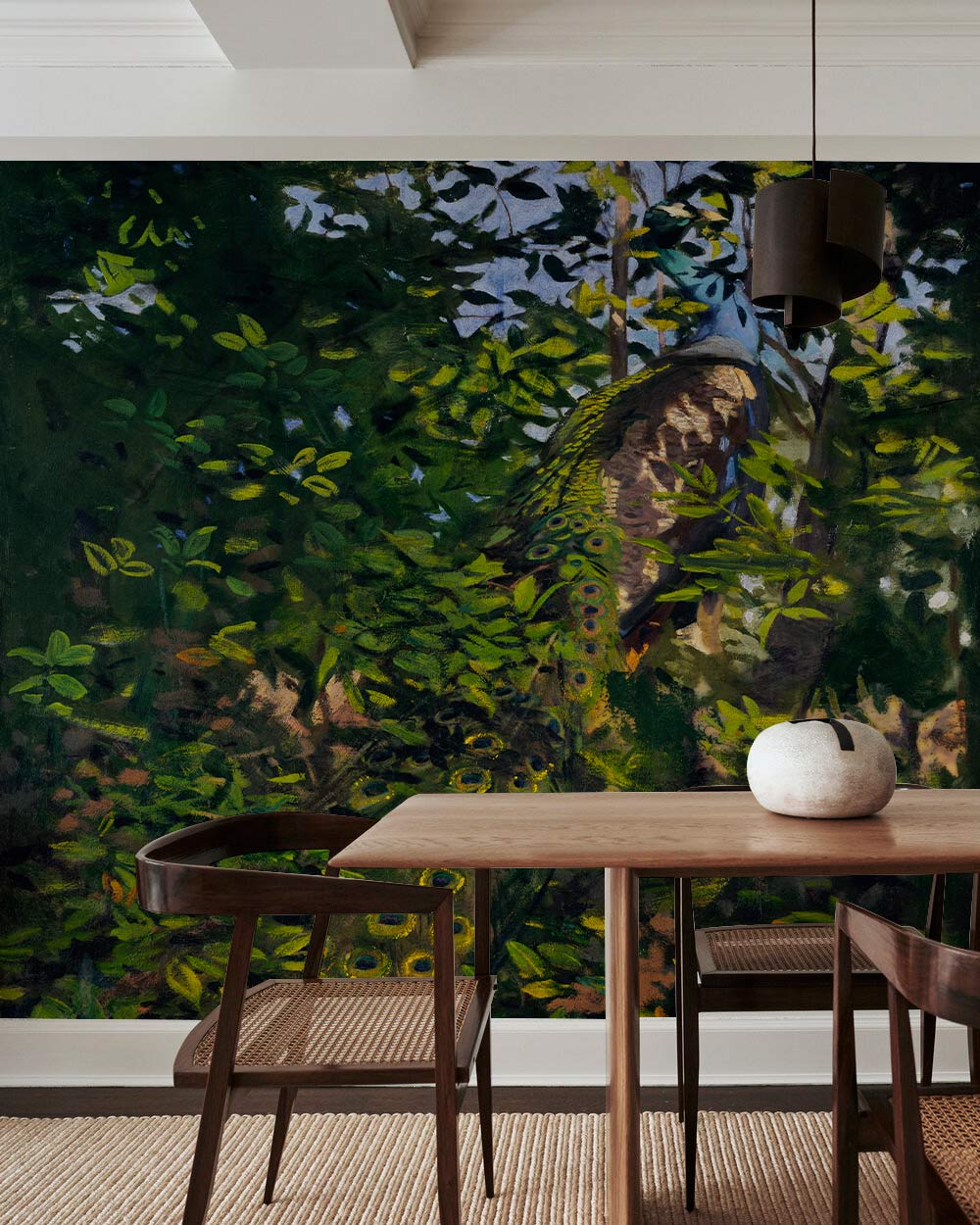 Enchanting Forest Peacock Mural Wallpaper in dining room with wooden table and chairs, modern decor.