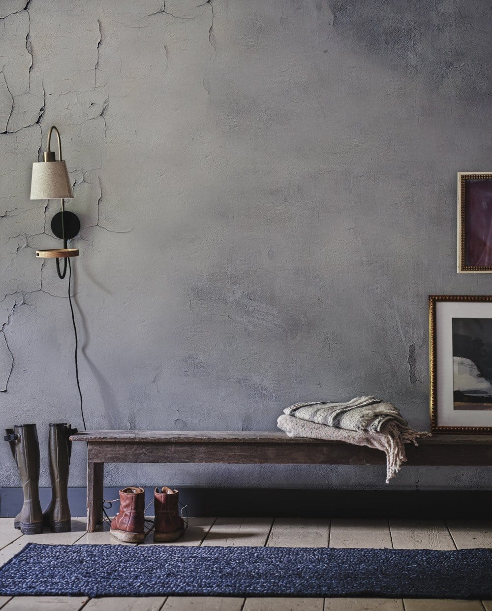 Vintage industrial aged concrete wallpaper, grey textured wall, rustic bench, entryway decor, tiled floor.
