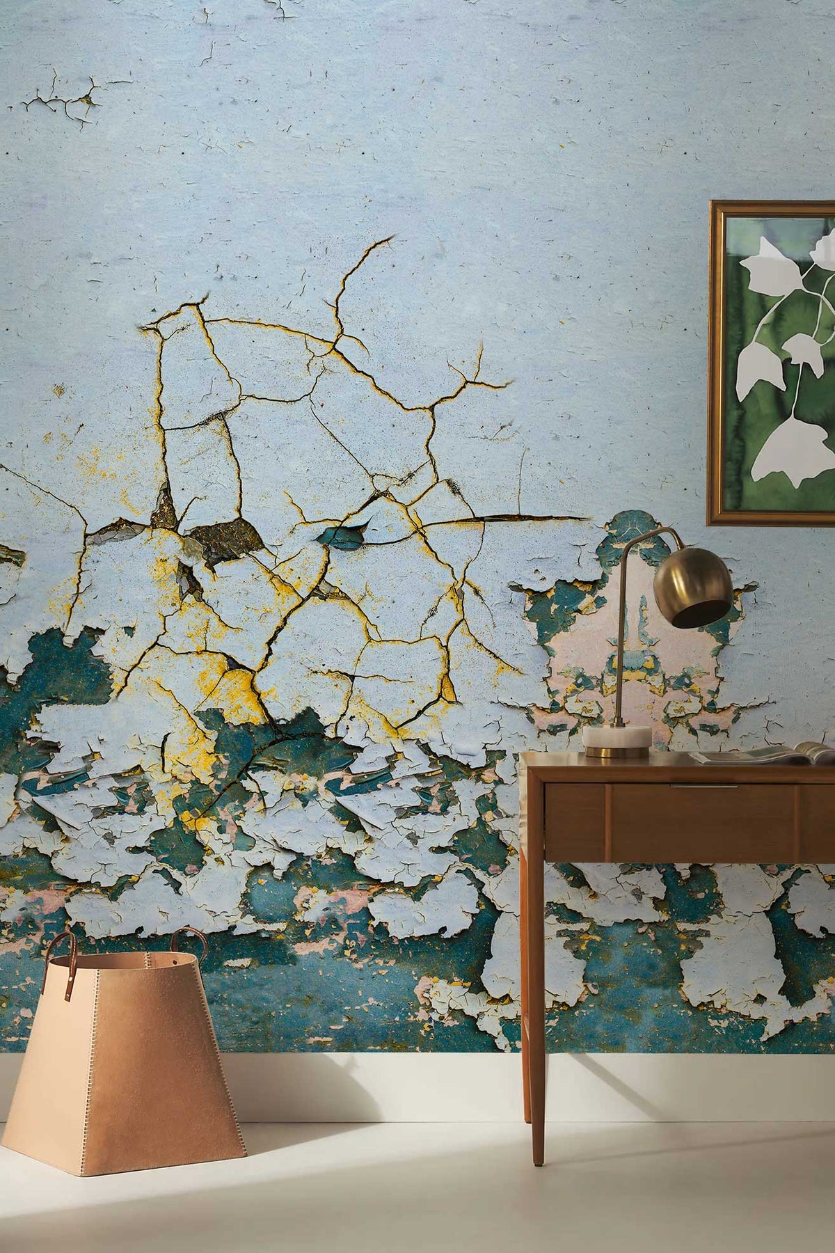 Vintage Patina Textured Wallpaper with distressed blue teal design, wooden desk, modern chair, framed artwork.