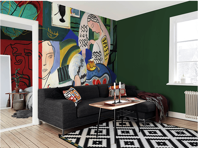 Artistic vibrant abstract mural wallpaper in living room with dark sofa, geometric rug, and wooden flooring.