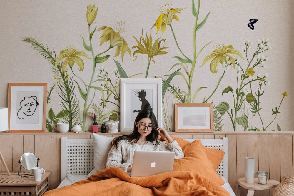 Vintage botanical mural, soft yellow and green, bedroom with wood panelling, framed artwork, cosy bedding.
