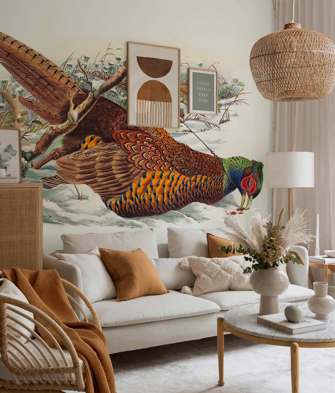 Vintage Pheasant Mural Wallpaper in rustic living room with white sofa, wicker chair, neutral tones.