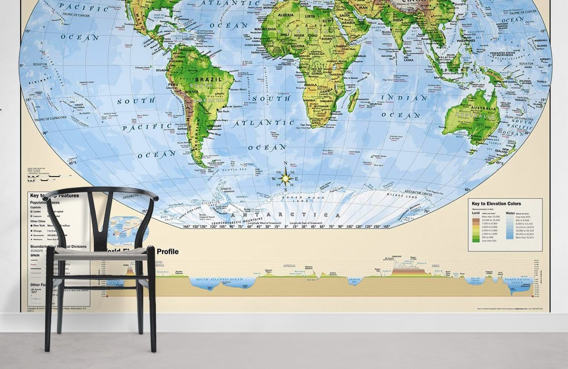 Chair on grey floor with Vintage World Map Mural Wallpaper, green and blue adventure theme.