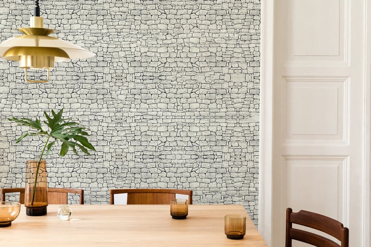 Rustic grey stone texture mural wallpaper, dining room with wooden table, chairs, and minimalist pendant light.