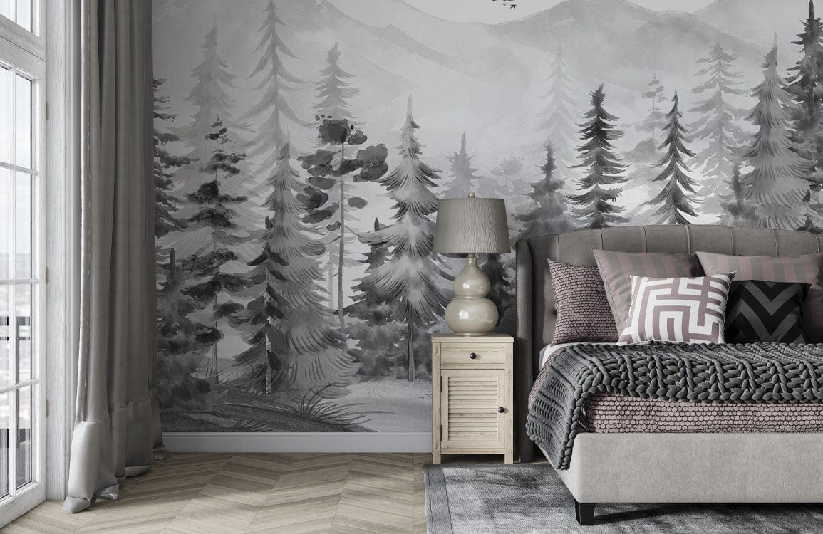 Monochrome forest mural wallpaper in bedroom with grey bed, cushion set, lamp, and chevron wood flooring.