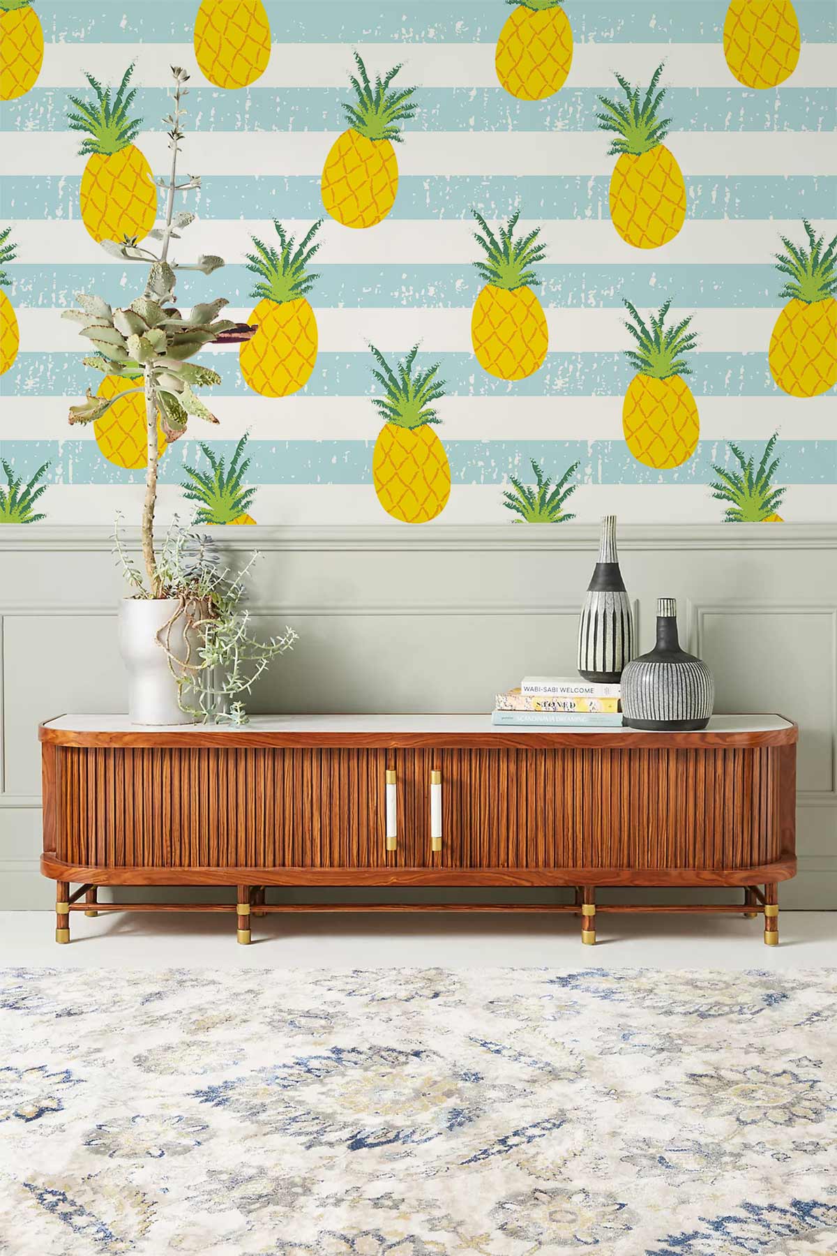 Tropical pineapple wallpaper, retro wooden sideboard, elegant grey panelling, ornate rug, vibrant living room Décor.