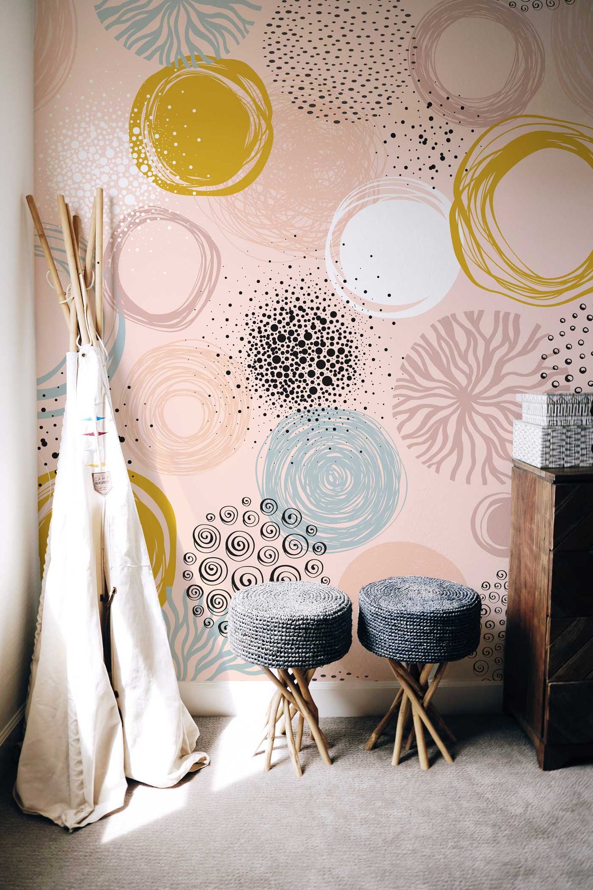 Abstract Pastel Circles wallpaper, yellow accents, modern decor, grey stools, carpeted floor, stylish room.