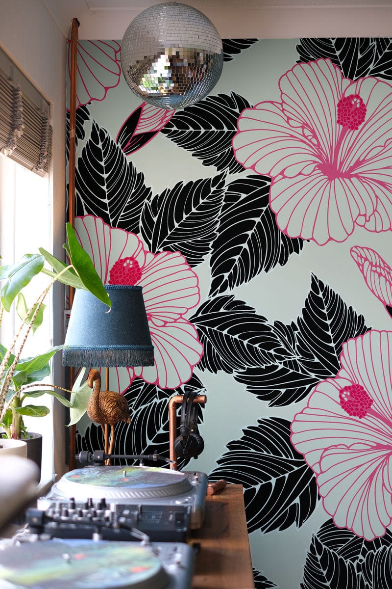 Elegant pink hibiscus floral wallpaper featuring bold black leaves, disco ball, and record player setup.