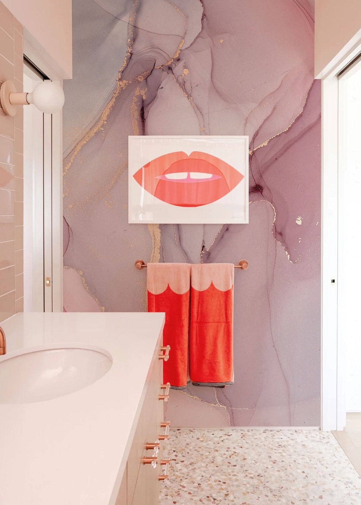 Elegant pink and gold marble effect mural wallpaper in bathroom with terrazzo flooring and modern Décor.