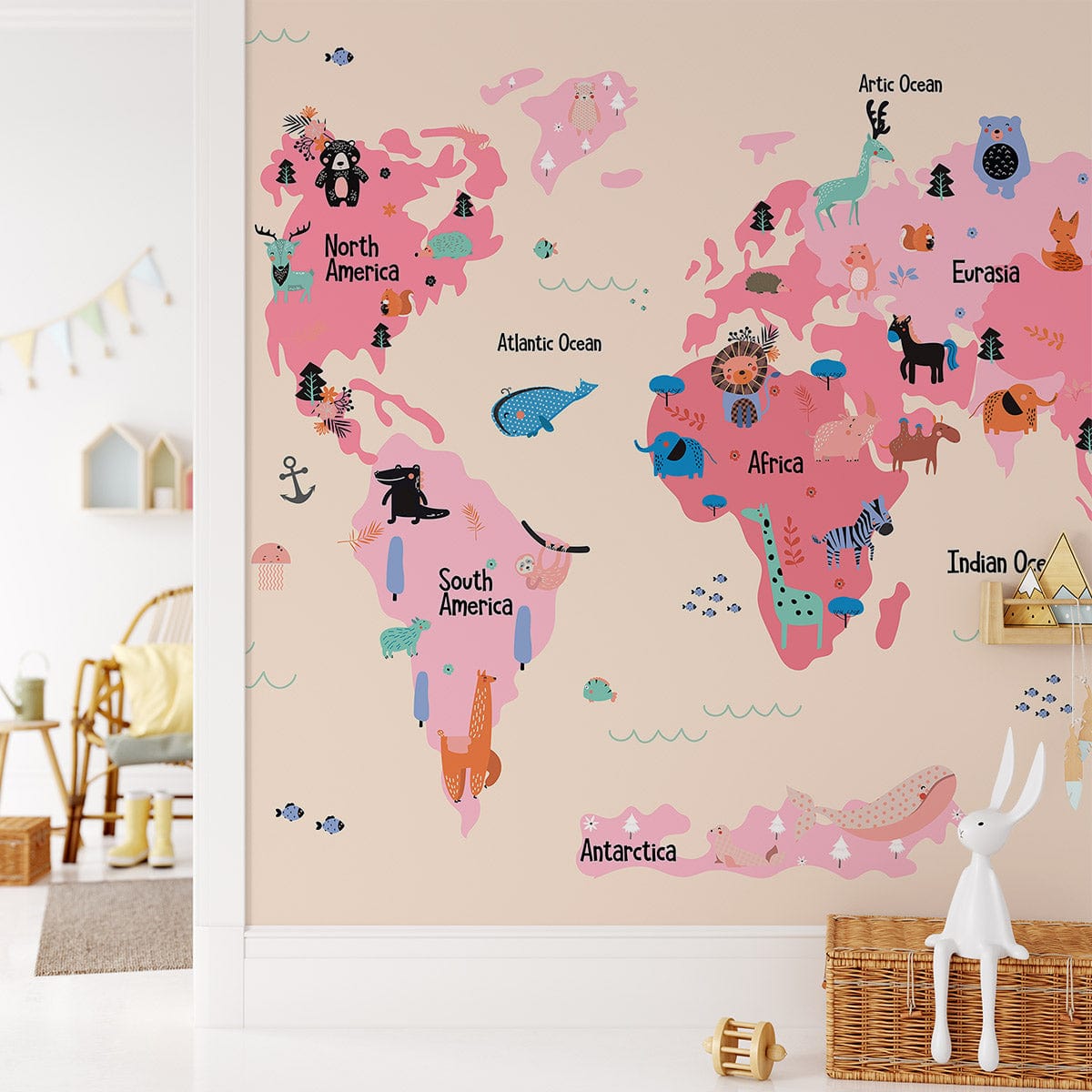 Colourful Animal World Map mural wallpaper in kids' room with beige walls, wicker basket, and wooden chair.