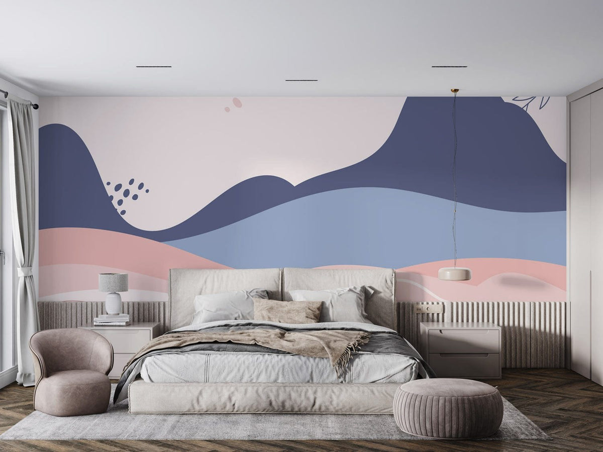 Abstract pastel landscape mural wallpaper in bedroom with beige bed, grey armchair, and wooden flooring.
