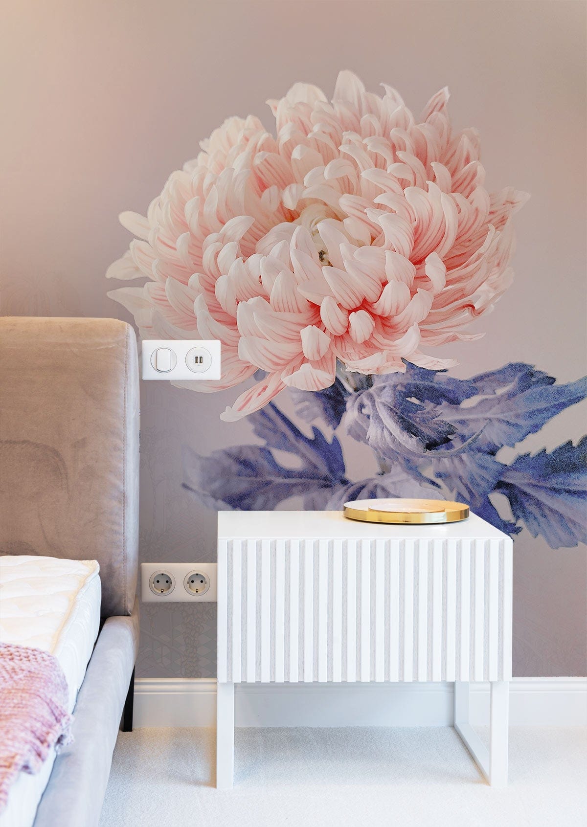 Elegant pink chrysanthemum wallpaper, soft mauve wall, plush grey bed, modern white bedside table, bedroom.