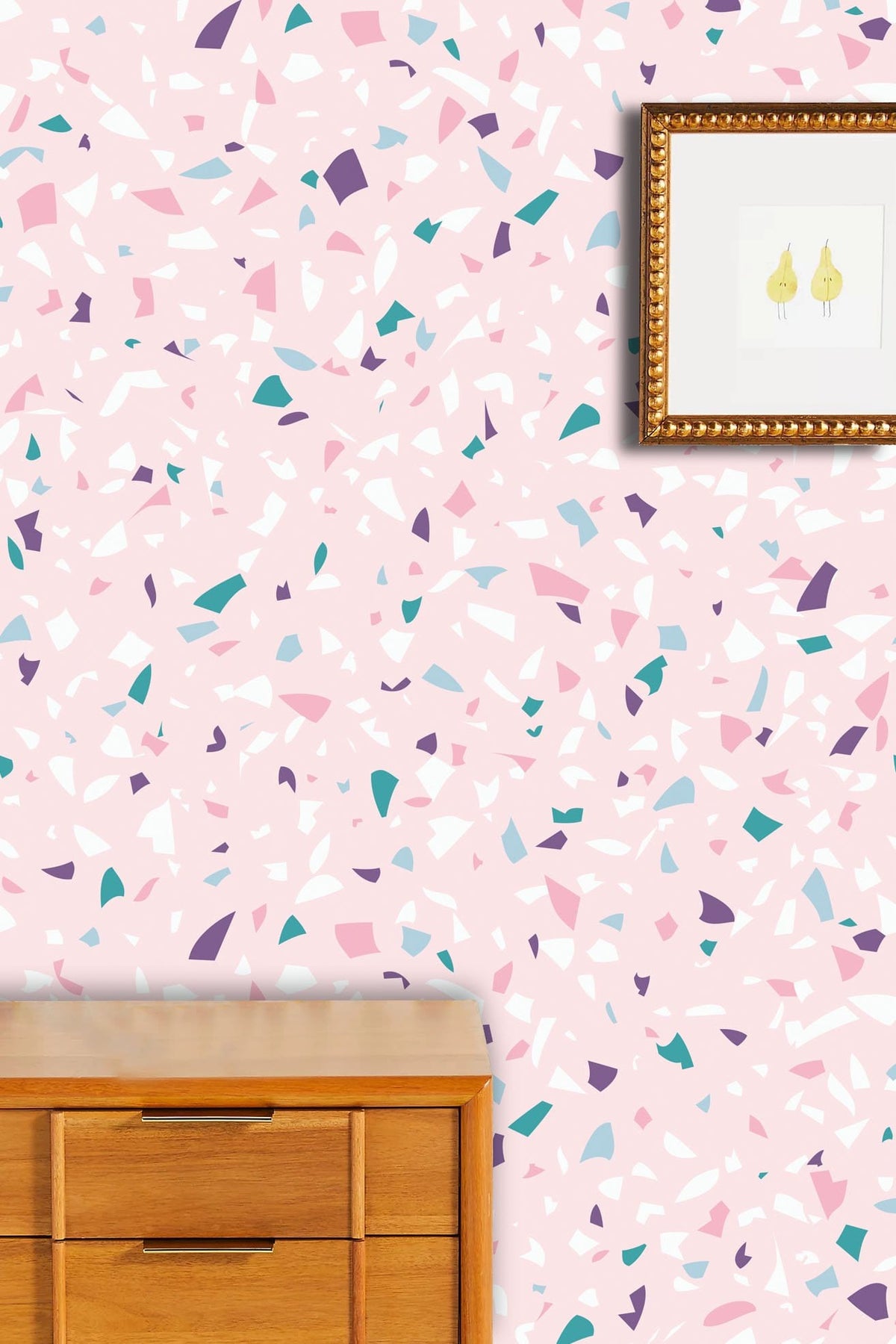 Pink terrazzo pattern wallpaper in modern room with wooden dresser and framed minimalist artwork.