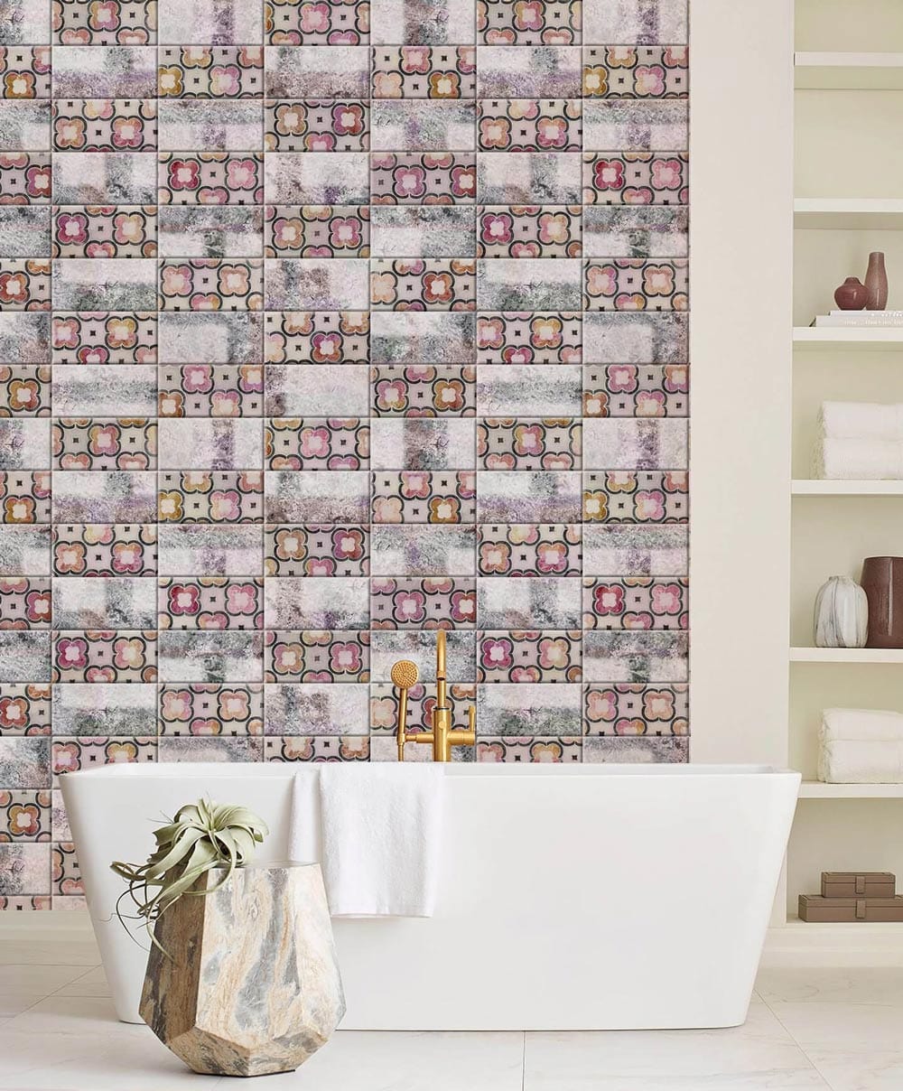Vintage patchwork wallpaper with geometric design in bathroom, white freestanding tub, tile flooring.