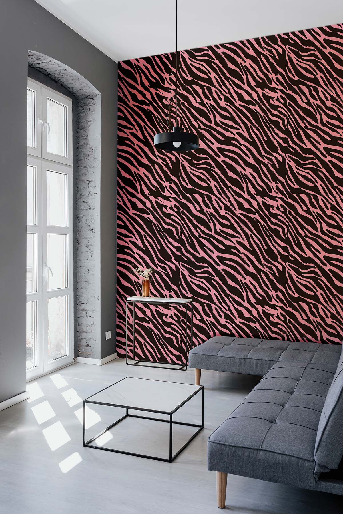 Pink and Black Zebra Pattern Wallpaper with grey sofa, modern black table, and natural light.