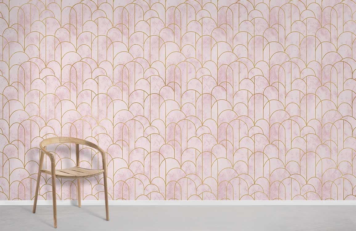 Blush pink art deco wallpaper with gold accents, light wooden chair, grey flooring in modern room.