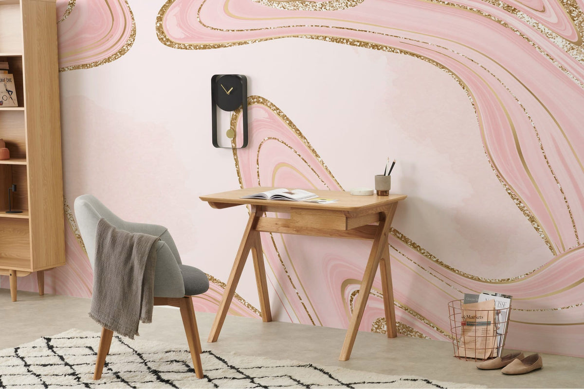 Elegant pink marble mural with glitter accents, wooden desk, grey chair, and geometric rug in study.