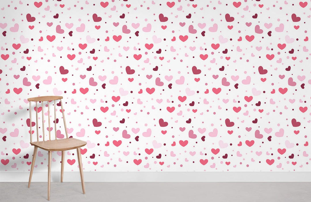 Pink hearts wallpaper with beige chair, grey floor; perfect for romantic interior design.