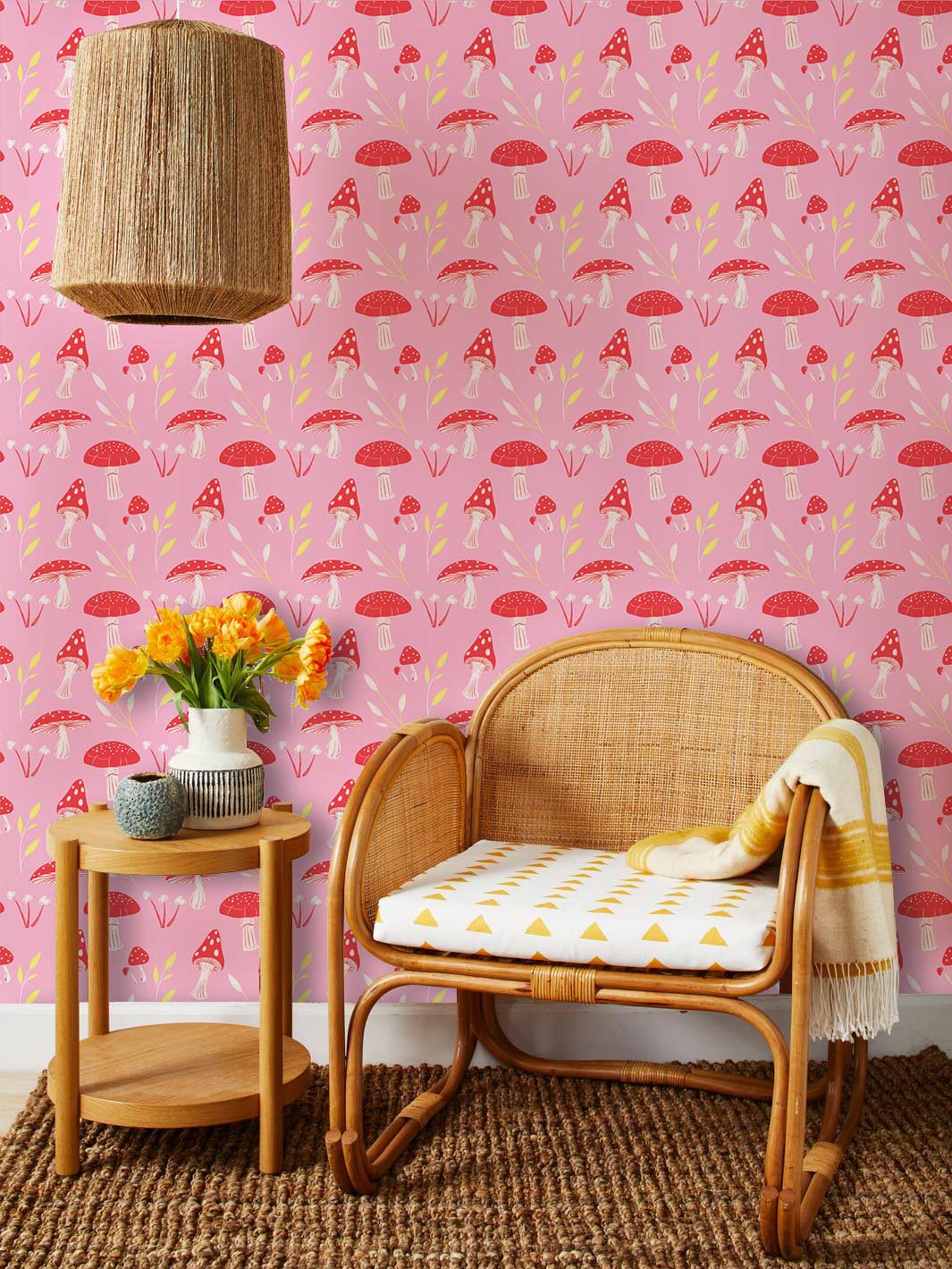 Charming pink mushroom wallpaper, wicker chair, rattan pendant light, woven rug, cottage style decor.