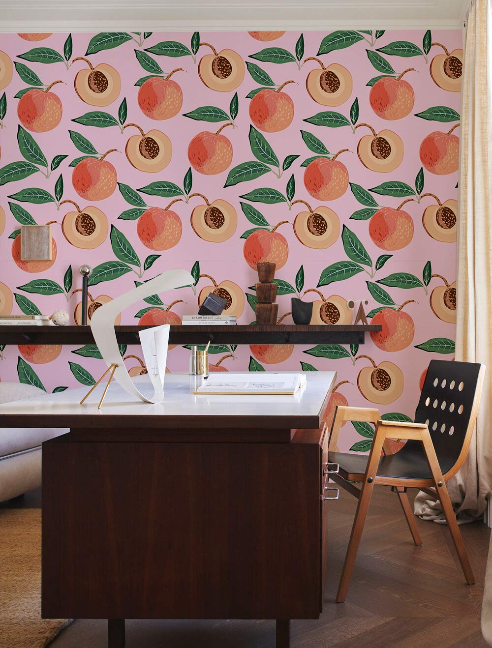 Vintage peach and green botanical wallpaper in a study room; modern desk, wooden chair, pastel decor.