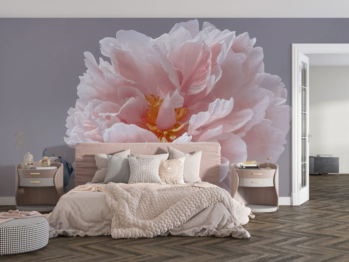 Graceful Blush Peony Floral Mural Wallpaper, pastel elegance, grey wall, plush bed, herringbone flooring.